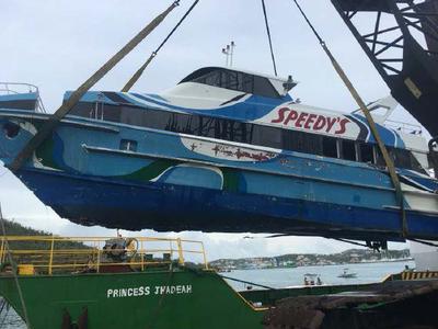 A boat is lifted in a sling